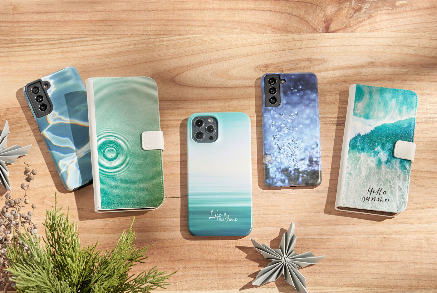 Schöne, personalisierte Handyhüllen in verschiedenen Designs auf einer Holzoberfläche